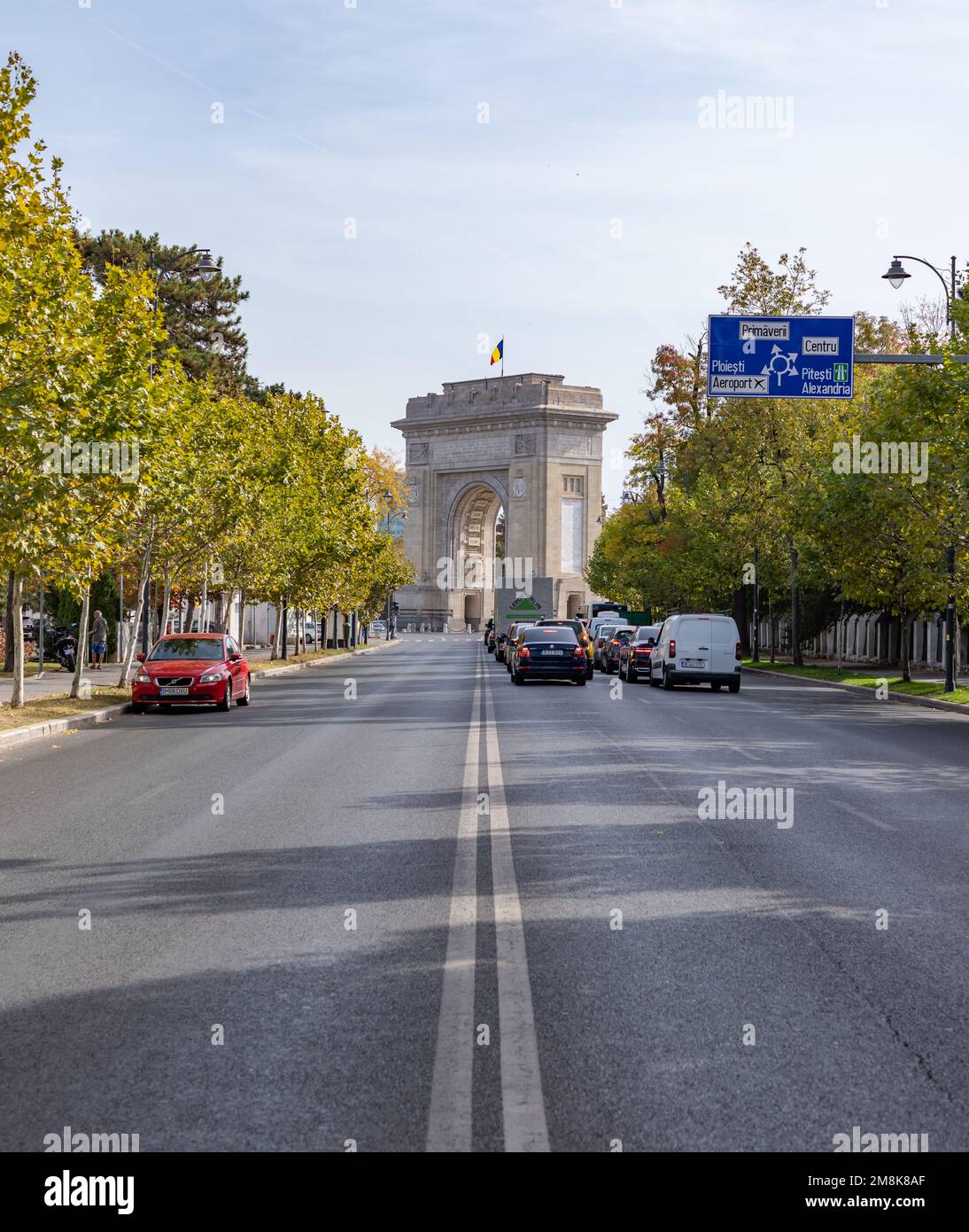 A picture of the Arch of Triumph of Bucharest at the end of the Alexandru Constantinescu Street. Stock Photo