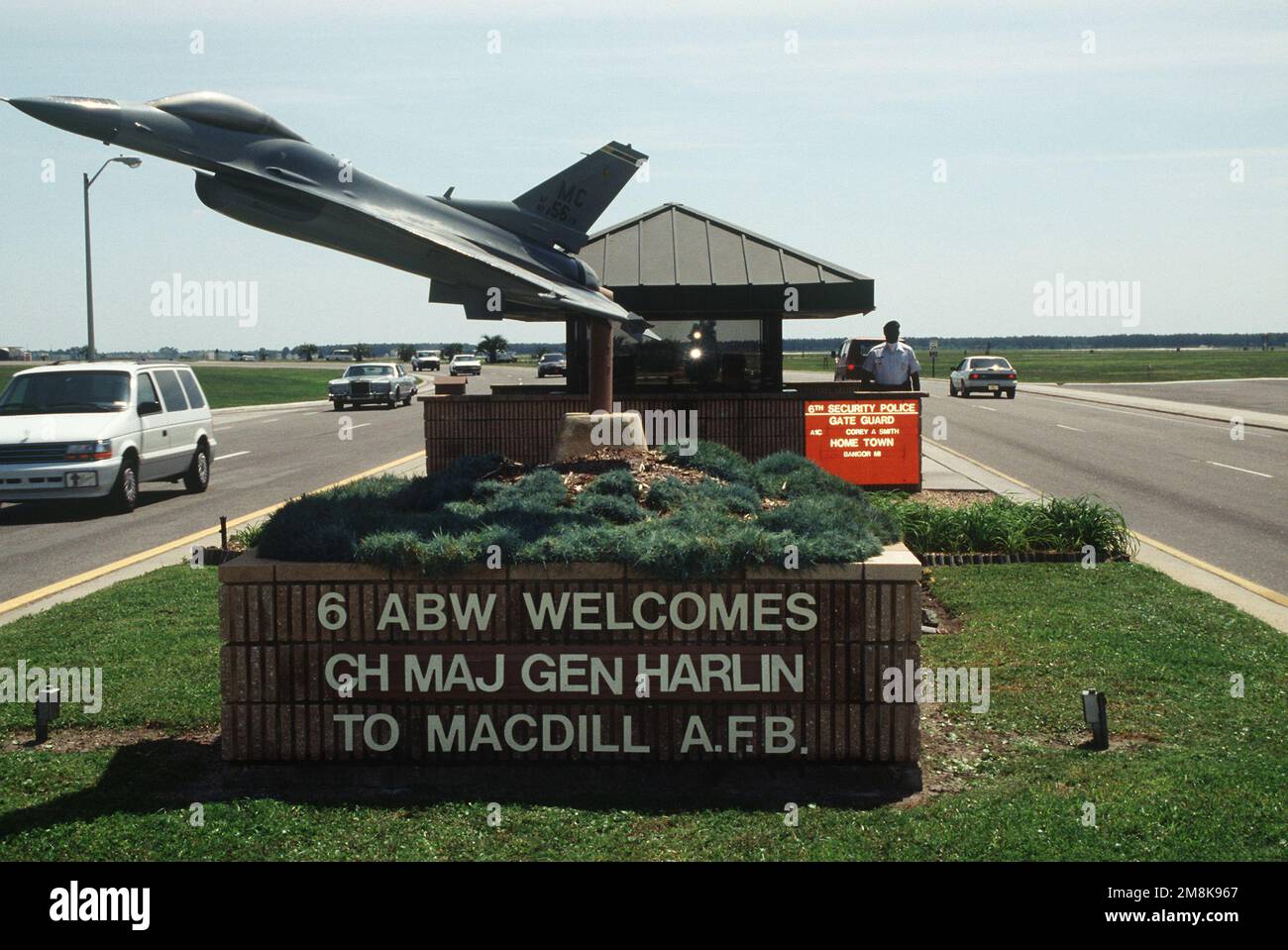 A closeup view of the base sign with a static F16. The main gate is