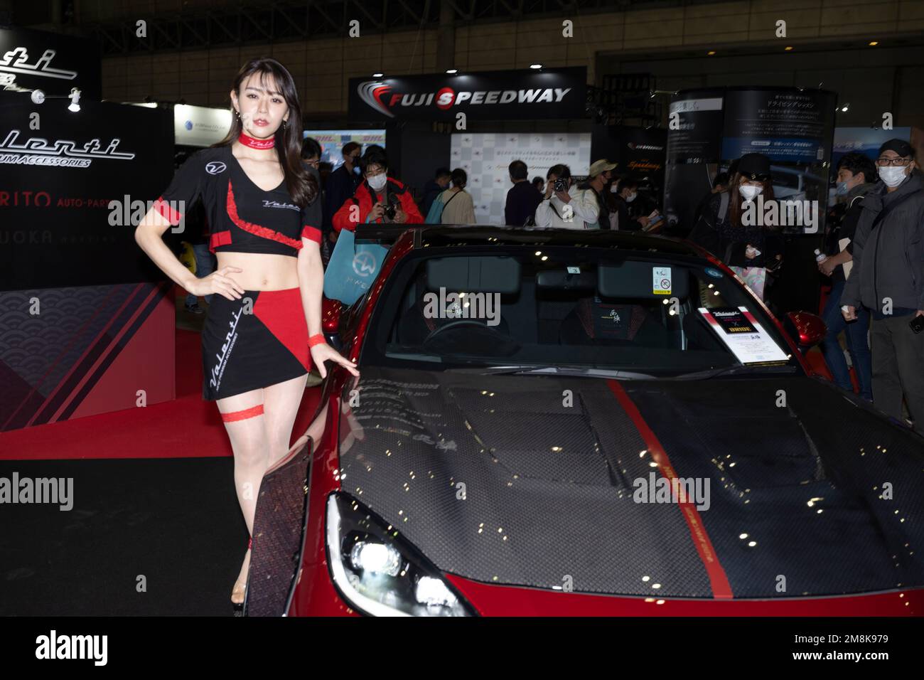 Chiba, Chiba Prefecture, Japan. 13th Jan, 2023. A model poses with a supercar.Tokyo Auto Salon (æ±äº¬ã‚ªãƒ¼ãƒˆã‚µãƒ-ãƒ³) is considered one of the most prestigious aftermarket car shows in the world, attracting car enthusiasts, manufacturers, and media from all over the globe. The show features a wide range of customized and high-performance cars, including sports cars, luxury cars, and even trucks and buses. Visitors can also expect to see car-related products and technology such as wheels, tires, audio systems, and car electronics. Some of the most notable manufacturers that participate Stock Photo