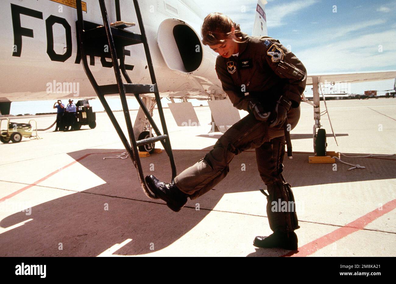 US Air Force CAPT. Karen Brown, a T-38 Talon Instructor Pilot with the 87th Flying Training Squadron, Laughlin Air Force Base, Del Rio, Texas, zips up her G-suit prior to climbing into the aircraft during the annual air defense exercise. Subject Operation/Series: ROVING SANDS '95 Base: Roswell State: New Mexico (NM) Country: United States Of America (USA) Stock Photo