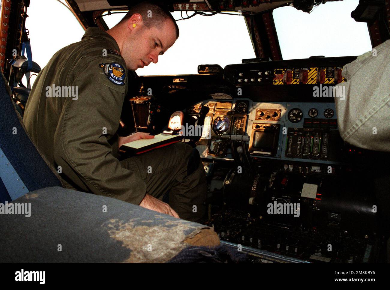 CAPT. Michael Stewart, a pilot from the 9th Airlift Squadron, accomplishes his pre-flight checks for his checkride during the 21st AF STANEVAL. Exact Date Shot Unknown. Base: Dover Air Force Base State: Delaware (DE) Country: United States Of America (USA) Stock Photo