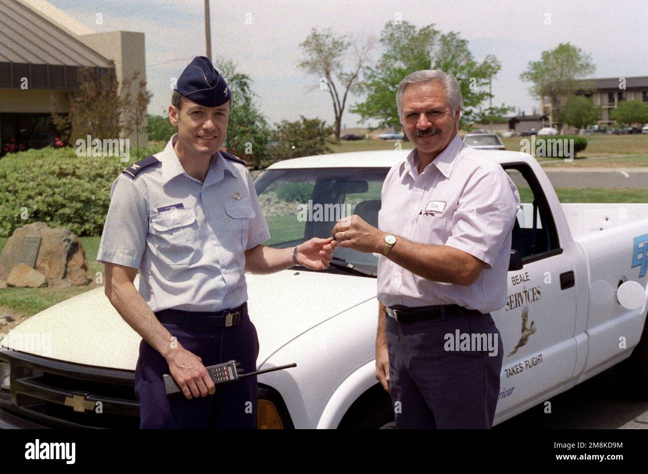 US Air Force Colonel James Donley, Commander, 9th Support Group, Beale Air Force Base, California, and Tom Johnson, 9th Services Squadron, hold the keys to Beale's first alternatively fueled vehicle built by US Electricar. According to Johnson, the program coordinator, the US government has mandated that 70 percent of all vehicles use by agencies be alternatively fueled vehicles. Base: Beale Air Force Base State: California (CA) Country: United States Of America (USA) Stock Photo