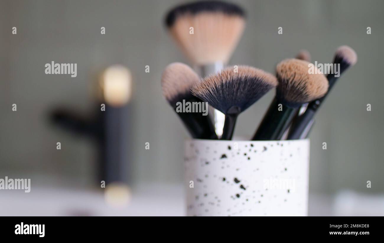 jar with makeup brushes in the bathroom Stock Photo