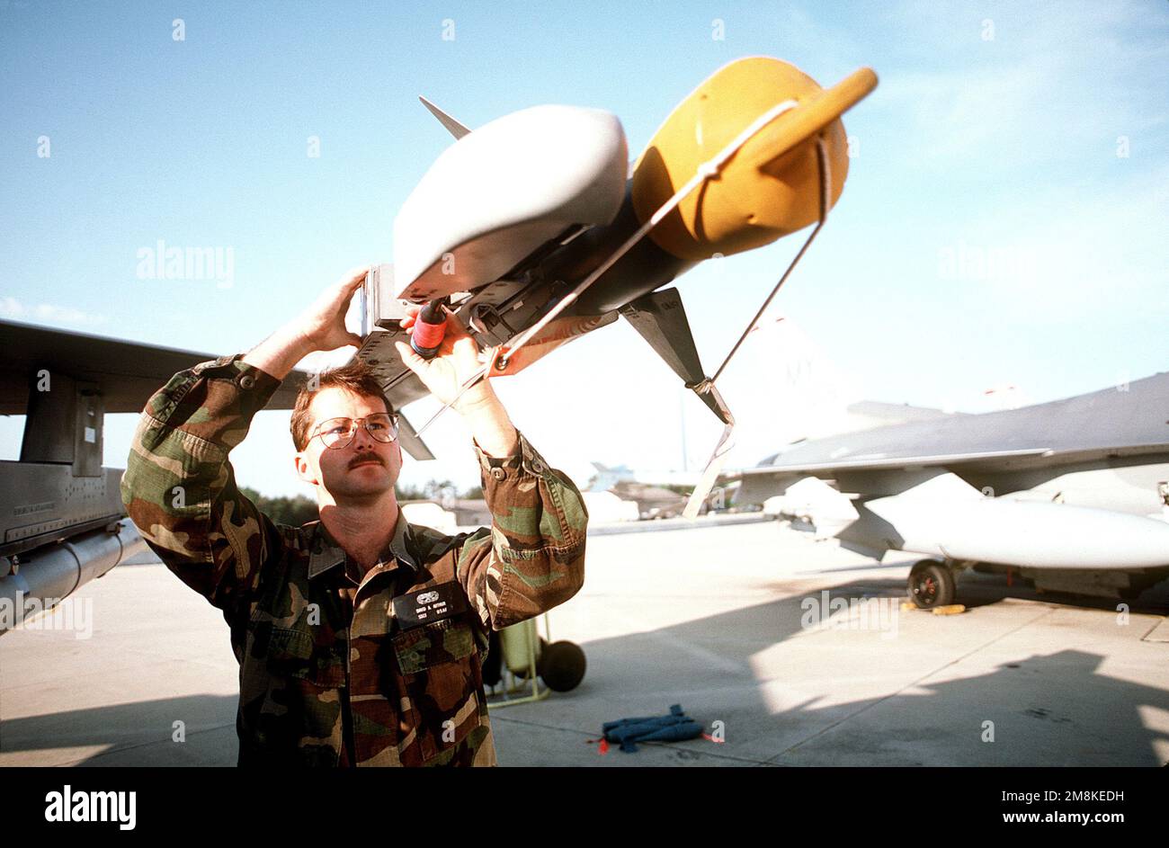 USAF Sergeant David A. Arthur connects the umbilical cord on an AIM9