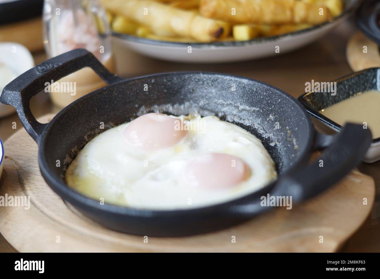 fried eggs in a frying pan Stock Photo