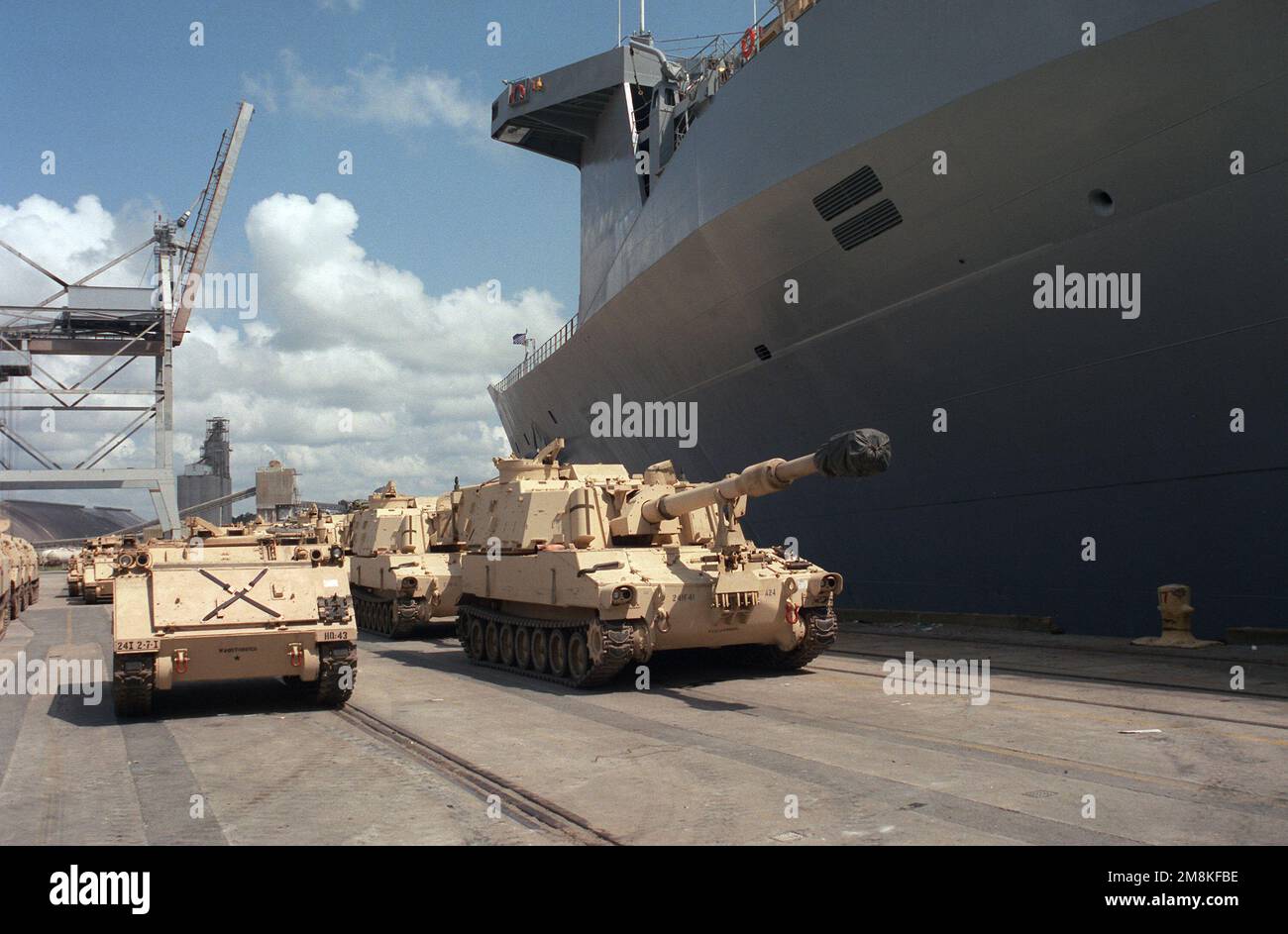 M113 Armored personnel carriers and M109 Paladins line the dock to be uploaded on board the US Naval Ship Capella (T-AKR-293) at the Savannah Port. Base: Fort Stewart State: Georgia (GA) Country: United States Of America (USA) Stock Photo