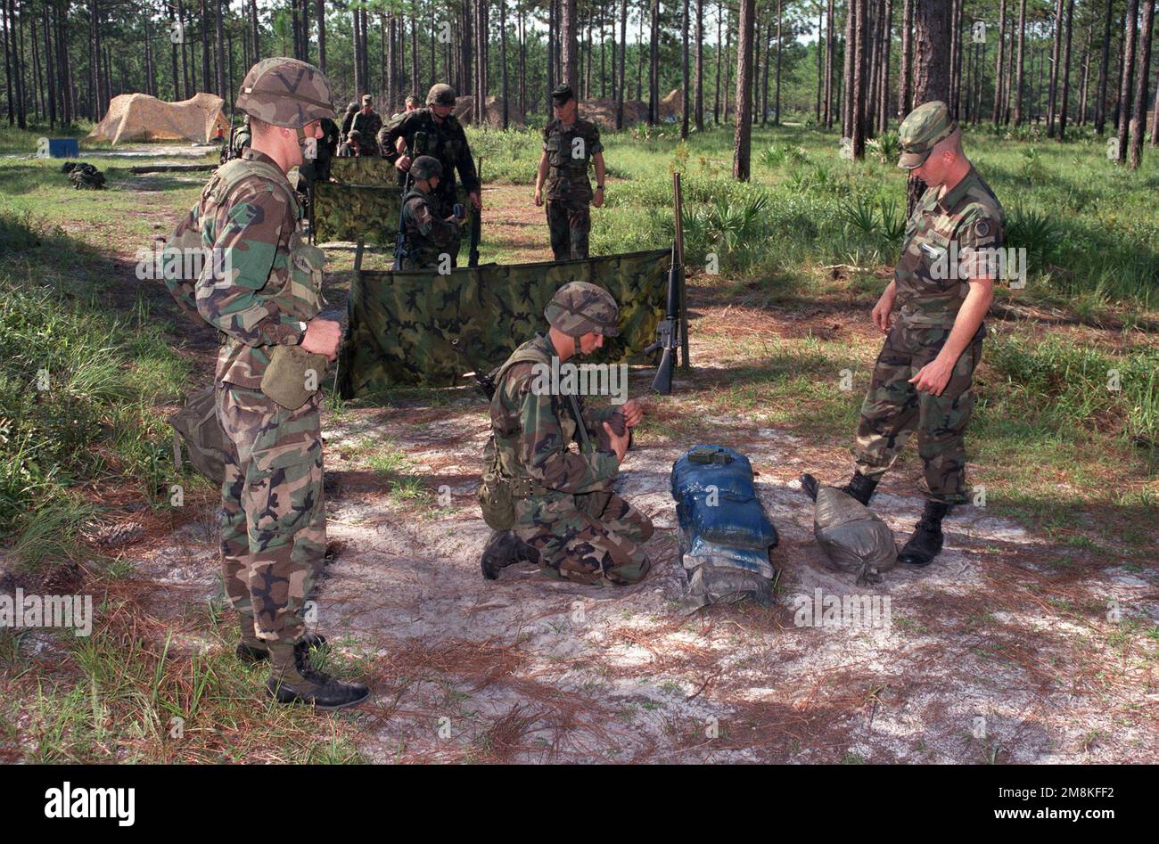 A medium range view of a soldier preparing a claymore mine during Expert Infantry Badge (EIB) training. Base: Fort Stewart State: Georgia (GA) Country: United States Of America (USA) Stock Photo