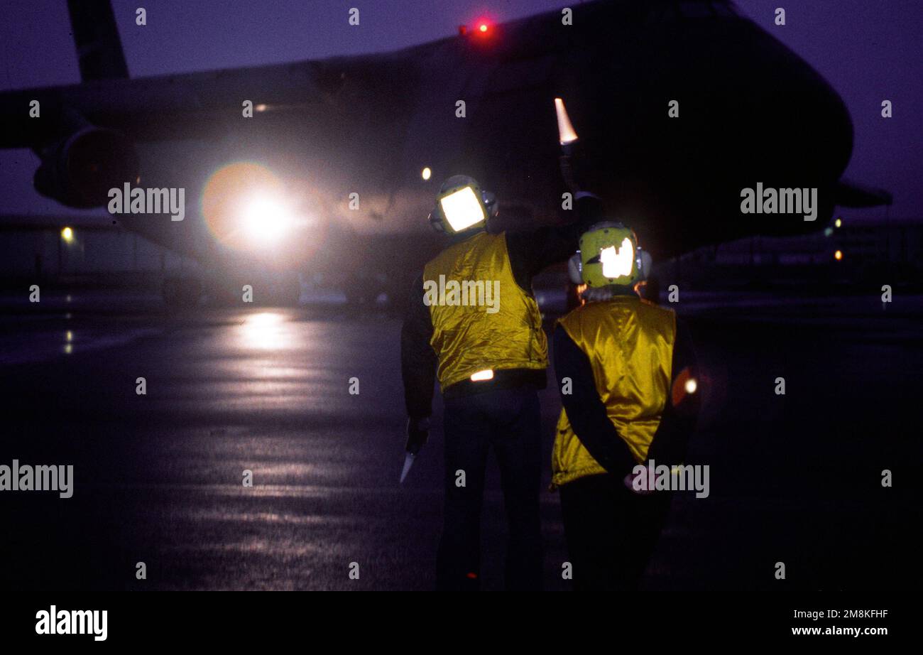 AMN Amus Forsyth, Air Operations, Keflavik NAS, marshals a C5 into a