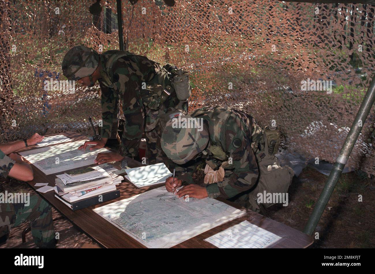 Soldiers plot coordinates on a map during Expert Infantry Badge (EIB) training. Base: Fort Stewart State: Georgia (GA) Country: United States Of America (USA) Stock Photo