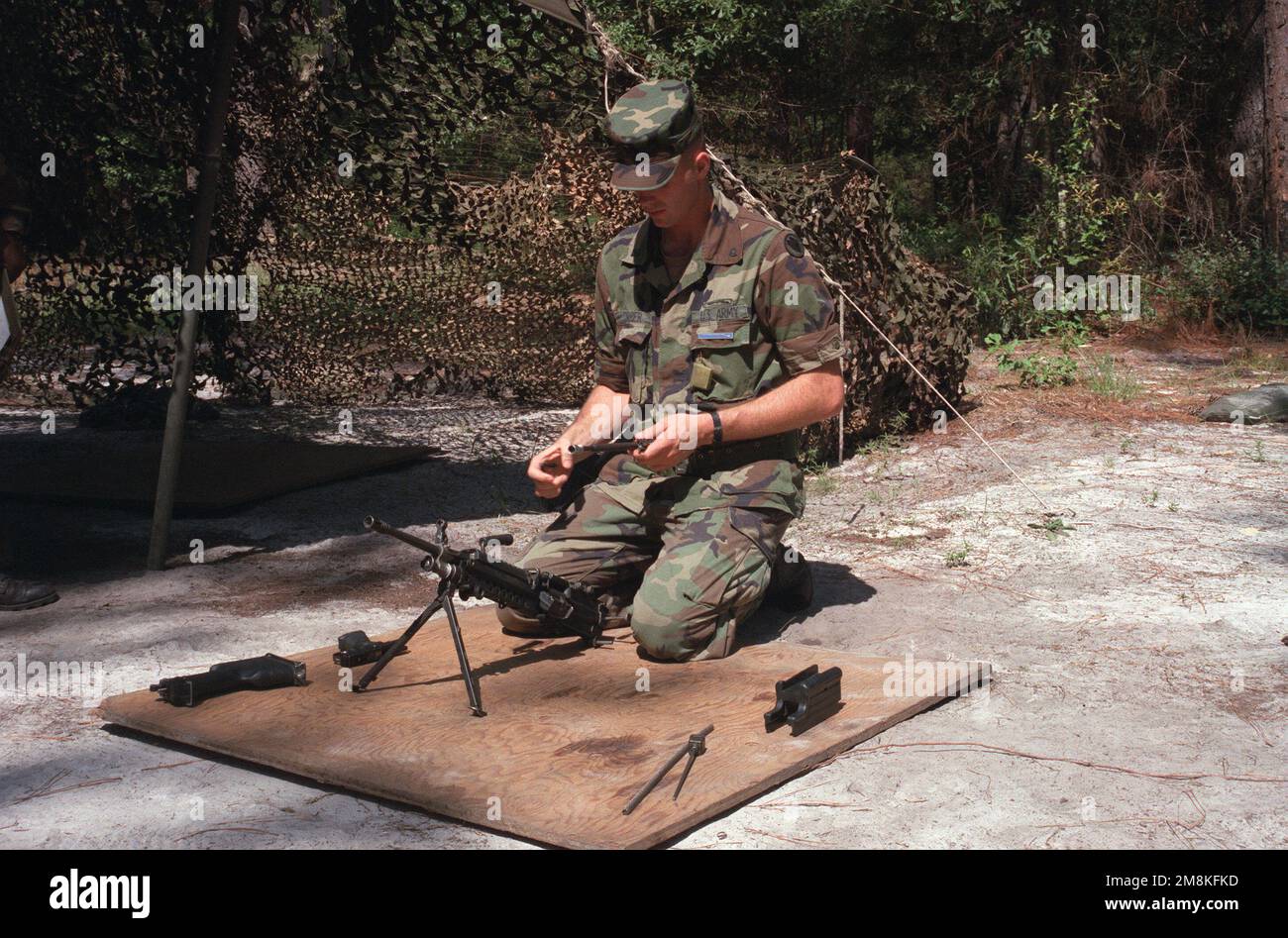 A soldier assembles the M249 squad automatic weapon during Expert Infantry Badge (EIB) training. Base: Fort Stewart State: Georgia (GA) Country: United States Of America (USA) Stock Photo