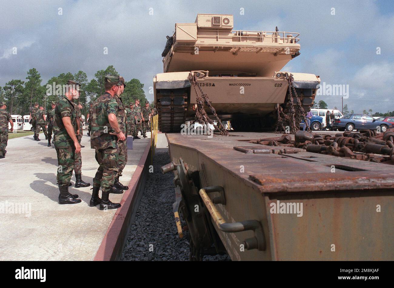 Members of the 24th Infantry Division (Mechanized) observe an M1 tank