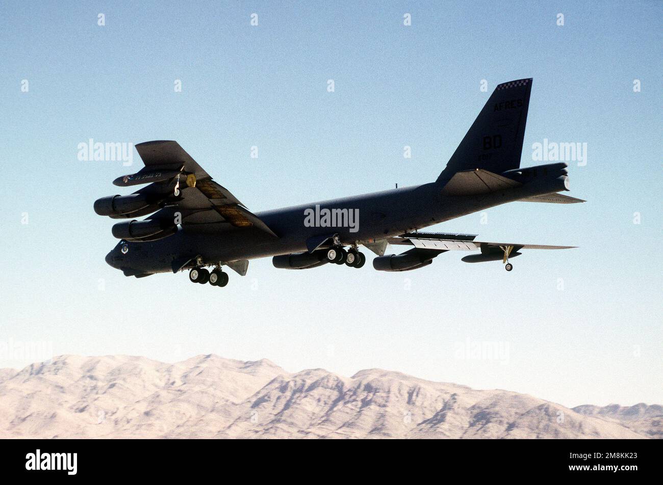 B-52 bomber, with wheels and flaps down, from the 917th Wing (Air Force Reserves), Barksdale Air Force Base, Louisiana approaches for a landing during GUNSMOKE '95. Exact Date Shot Unknown. Subject Operation/Series: GUNSMOKE '95 Base: Nellis Air Force Base State: Nevada (NV) Country: United States Of America (USA) Stock Photo