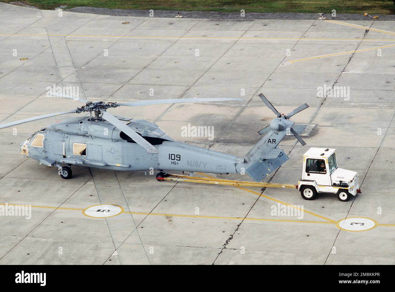 An SH60B Seahawk helicopter of Helicopter Squadron One (HS1) is towed