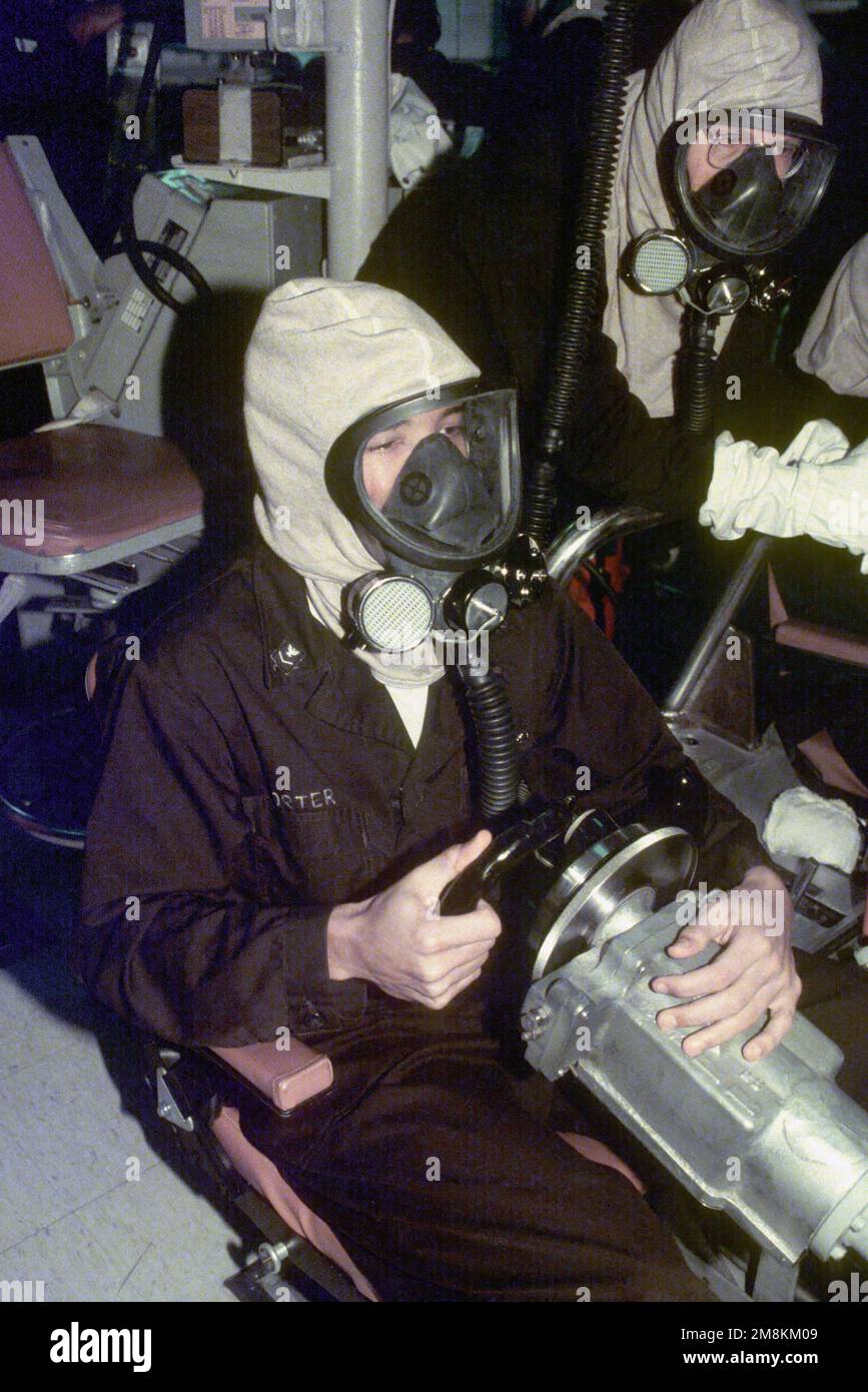 Sailors man their post in the Ship Control Station during a security drill on board the nuclear-powered ballistic missile submarine USS PENNSYLVANIA (SSBN-735). All personnel are wearing Oxygen Breathing Apparatus (OBA). Country: Unknown Stock Photo