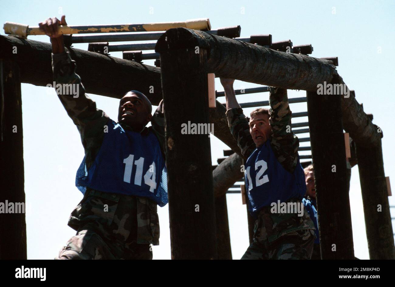Competing at PEACEKEEPER CHALLENGE '96, US Air Force SENIOR AIRMAN Joseph A. Weyers (left) and US Air Force Technical Sergeant Kevin Westermeyer (right) conquer the monkey bars. Fourteen security police teams representing 12 Air Force major commands, the Royal Air Force and the Canadian Forces Air Command, fought it out during a week of grueling competition called PEACEKEEPER CHALLENGE. This image was used in the January 1996 issue of AIRMAN Magazine. Subject Operation/Series: PEACEKEEPER CHALLENGE '96 Base: Kirtland Air Force Base State: New Mexico (NM) Country: United States Of America (USA) Stock Photo