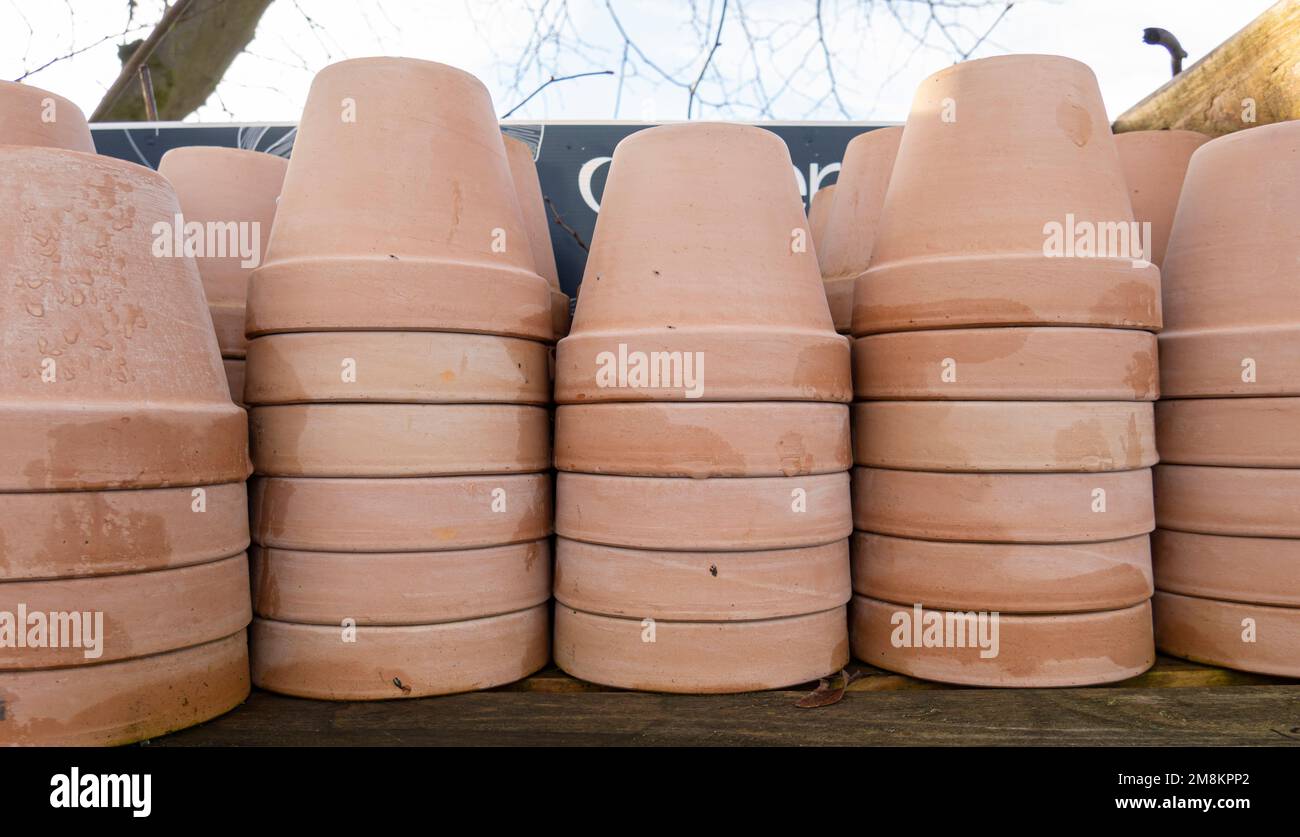 Stacks of various terracotta pots for plants for sale at a garden store