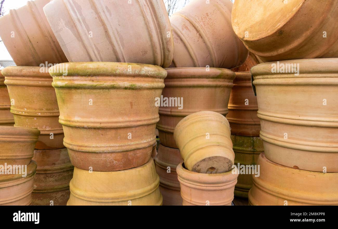 Stacks of various terracotta pots for plants for sale at a garden store