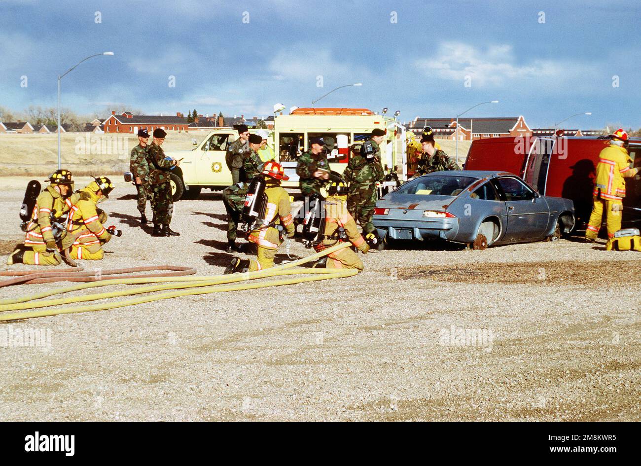 Firefighters and police officers work in harmony to rescue a trapped 'victim' with the IG members looking on. The Inspector General Team tested the ability of the base to respond to battle conditions, power outages, mobility deployments, aircraft and automobile accidents, hostage situations, bomb threats, armed robberies, terrorism, and communication problems. Subject Operation/Series: Operational Readiness Inspection, 90th Space Wing, 11-25 Mar Base: Francis E. Warren Air Force Base State: Wyoming (WY) Country: United States Of America (USA) Stock Photo