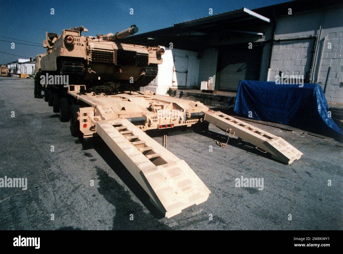 Elements of the 24th Infantry Division (Mechanized) load an M-1 Abrams ...