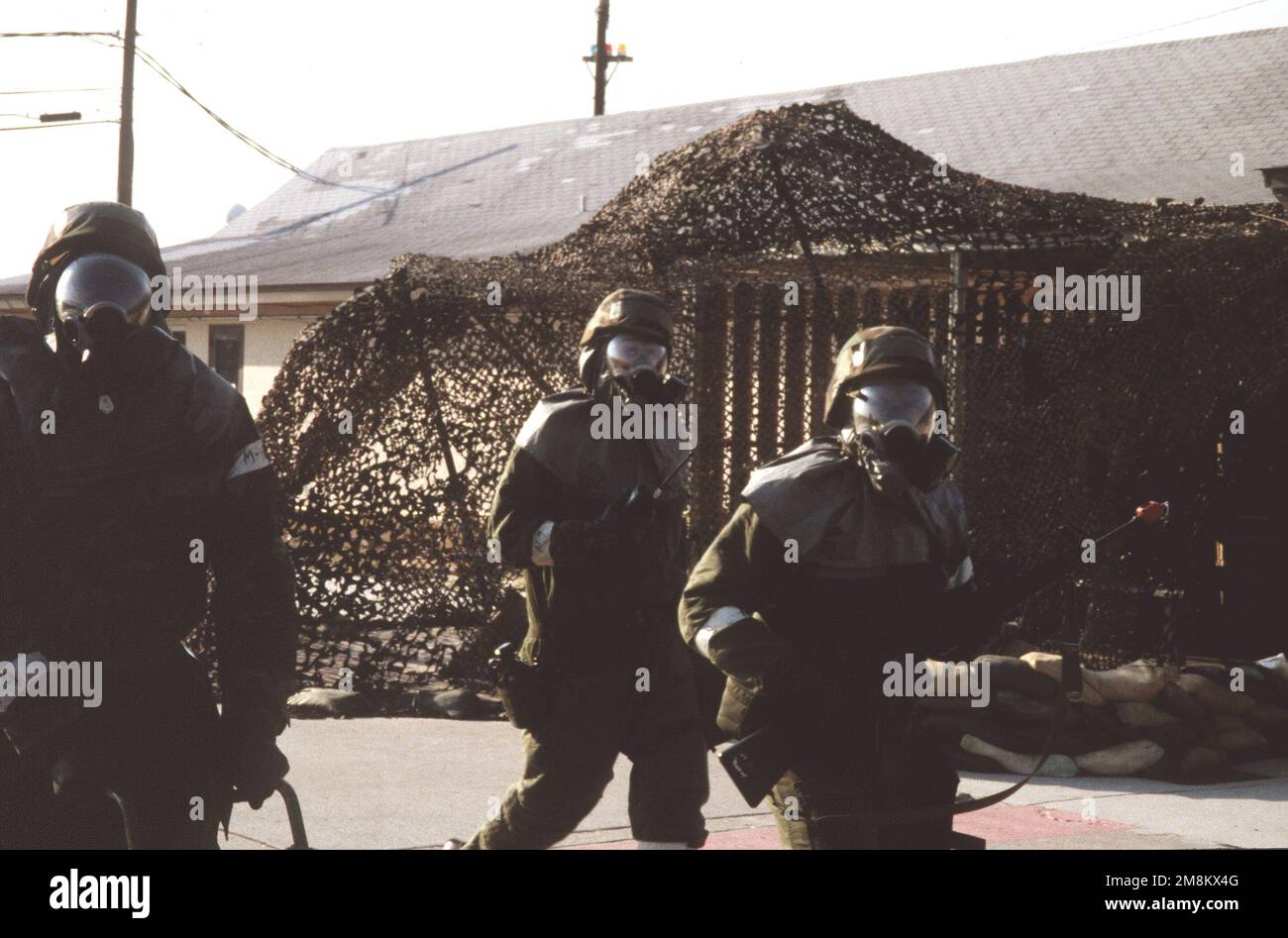 During Condition Red, three security policemen guard the Base Operations  Complex in Mission-Oriented Protective Posture response level 4 (MOPP-4)  gear during the 169th Fighter Wing Operational Readiness Inspection (ORI).  Base: Mcentire Ang