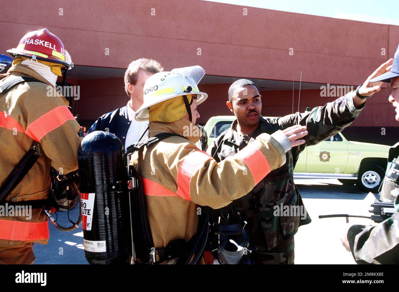 MASTER SGT. Allen Taylor, a member of the 90th Supply Squadron (SUPS), explains where the chemical was spilled and how the accident happened to Mr. Gregorio, a Rescue Firefighter from the 90th Civil Engineering Squadron. The Inspector General Team tested the ability of the base to respond to battle conditions, power outages, mobility deployments, aircraft and automobile accidents, hostage situations, bomb threats, armed robberies, terrorism, and communication problems. Subject Operation/Series: Operational Readiness Inspection, 90th Space Wing, 11-25 Mar Base: Francis E. Warren Air Force Base Stock Photo