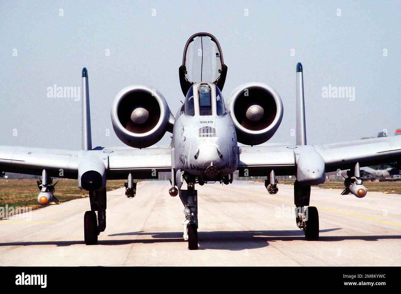 An A10 Thunderbolt II aircraft sits on the runway with the canopy up