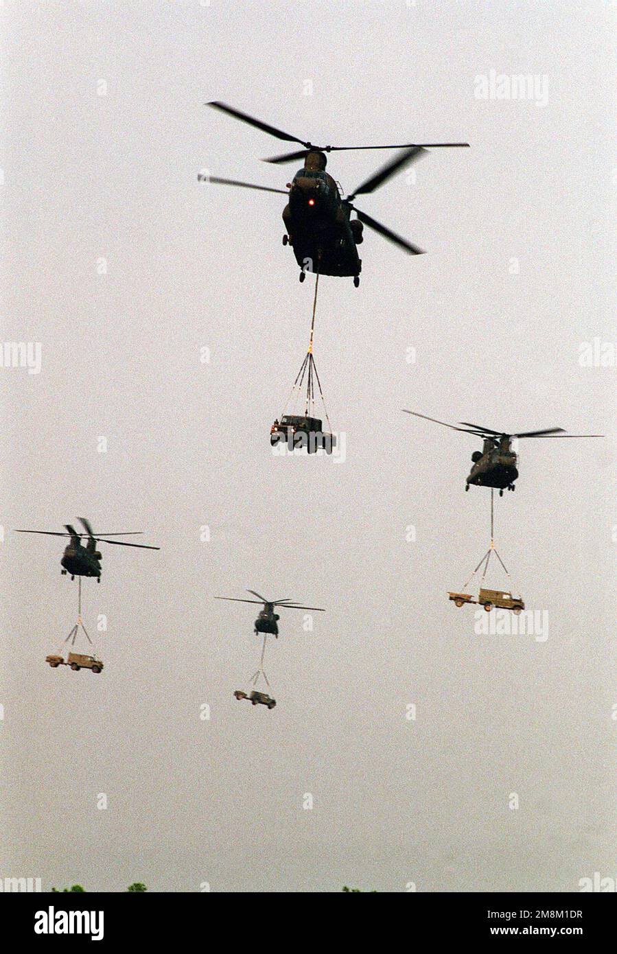US Army CH-47s ferry in British Royal Marine Land Rovers during the helo insertion to Drop Zone Luzon near Fort Bragg N.C., where the British Royal Marines along with U.S. Marines from 1ST Battalion, 8th Marine Regiment, and 3rd Battalion, 8th Marine Regiment were to conclude the CJTFEX '96. Subject Operation/Series: Combined Joint Training Field Exercise (CJTFEX) 96 Base: Camp Mckall State: North Carolina (NC) Country: United States Of America (USA) Stock Photo