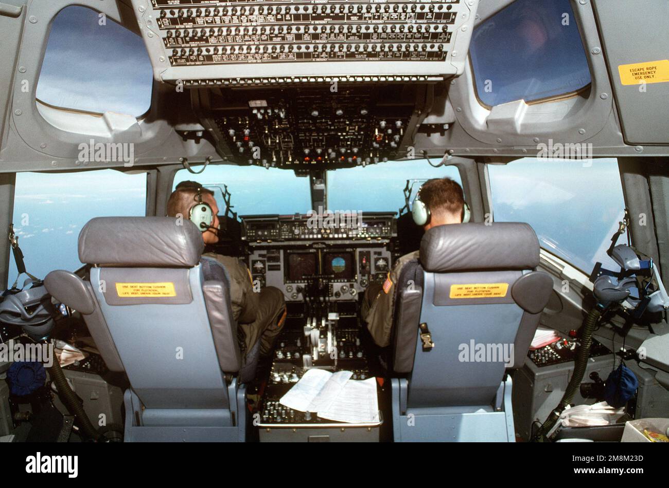 Pilots in the cockpit of a C-17 Globemaster III from the 17th Airlift Squadron, Charleston AFB, South Carolina, are on their maiden flight to Kuwait City International Airport, Kuwait. Eight C-17s participated in the operation which marks the first full-scale exercise assignment for Air Mobility Command's newest aircraft. They completed a strenuous evaluation earlier in the month. Subject Operation/Series: INTRINSIC ACTION Country: Atlantic Ocean (AOC) Stock Photo