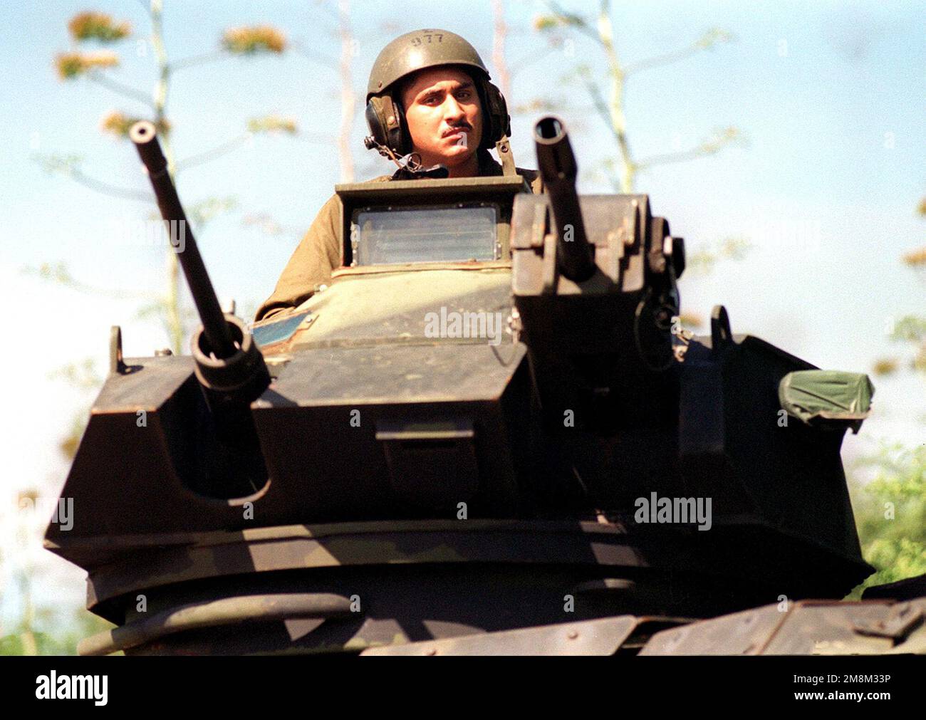 US Marine Corps Lance Corporal Fabian Jasso mans the gun turret of an Assault Amphibious Vehicle (AAV) during an amphibious assault conducted as part of RIMPAC 96 at Pacific Missile Range Facility, Barking Sands, Kauai, Hawaii, by the 11th Marine Expeditionary Unit from Camp Pendleton, California, and involved Navy and Marine air, ground and sea forces for training as a combined amphibious assault force. Subject Operation/Series: RIMPAC '96 Base: Kauai State: Hawaii (HI) Country: United States Of America (USA) Stock Photo