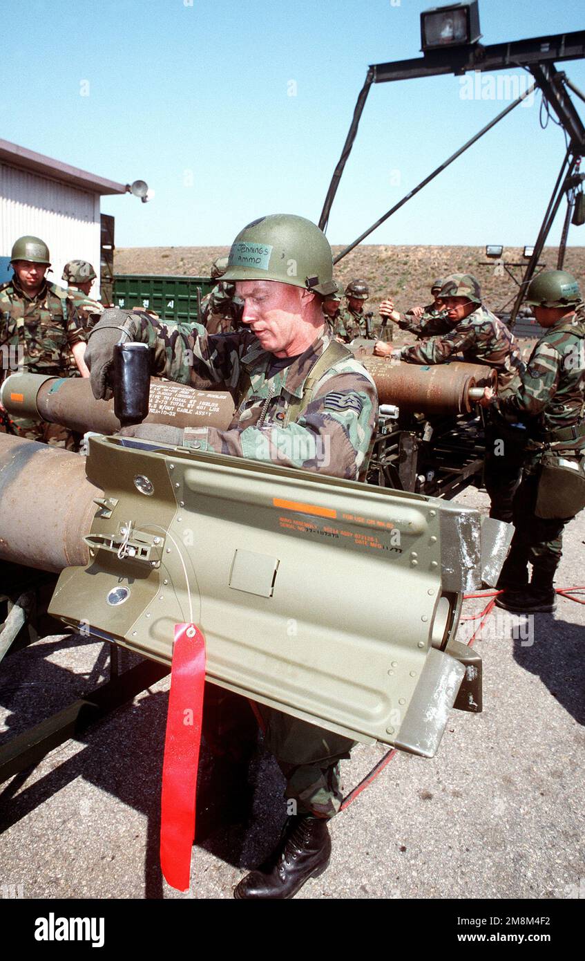 STAFF SGT. Paul Cornell, 23rd Munitions Squadron, Pope AFB, NC, attaches fins to a GBU-12 bomb during this combat ammunition production exercise.Published in AIRMAN Magazine July 1996. Exact Date Shot Unknown. Subject Operation/Series: CAPEX 96 Base: Suwon Air Base Country: Korea Stock Photo