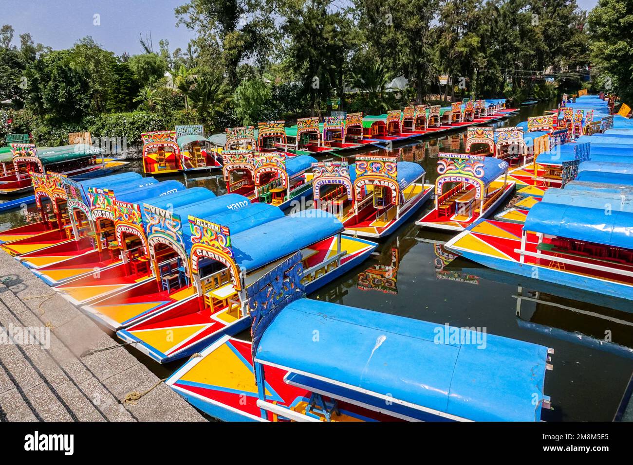 Colorful painted trajinera boats waiting for tourists to travel the