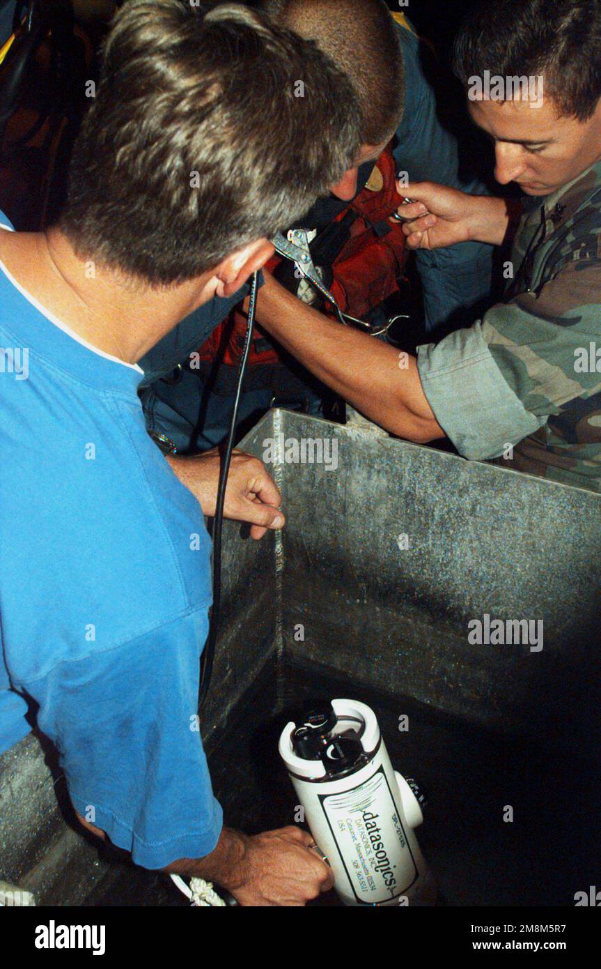 US Navy Engineman 2nd Class Anthony Bartelli (right) holds an