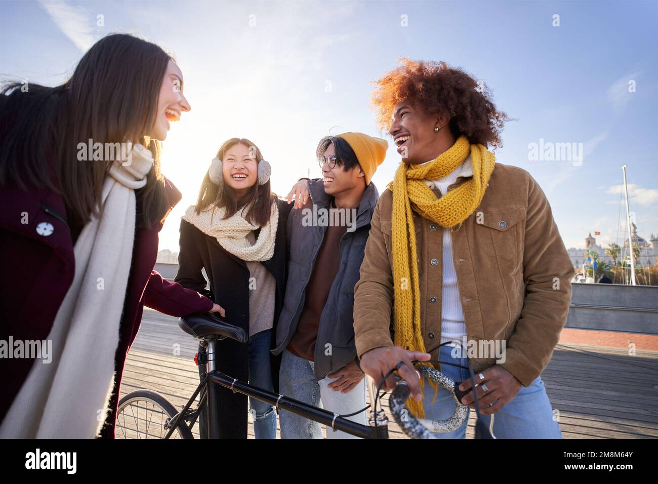 Cheerful Group of guys walking down street having fun. Multiracial