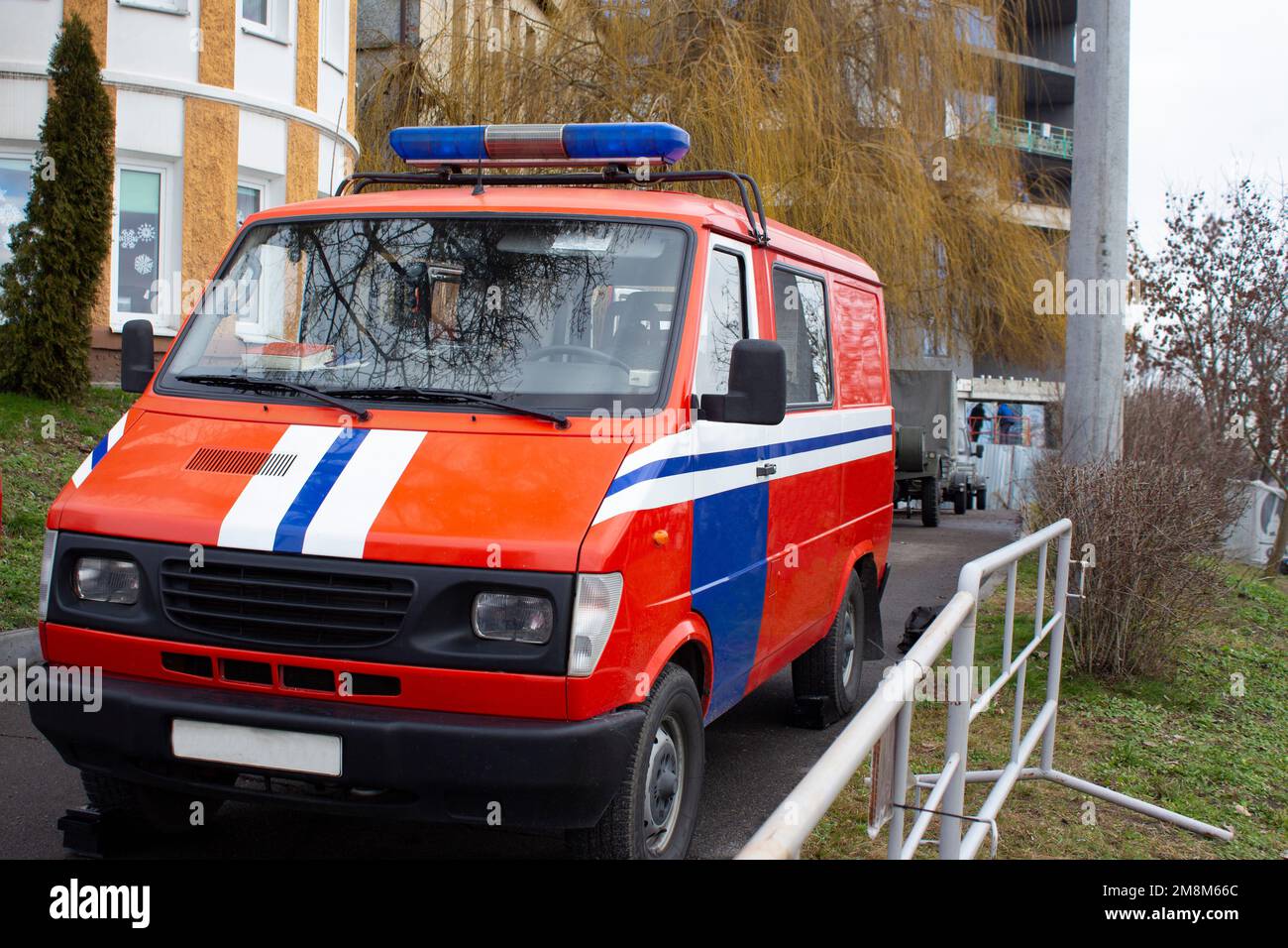 Red Rescue Vehicle. Rescue team parks its rescue vehicle for fire safety inspection. Stock Photo