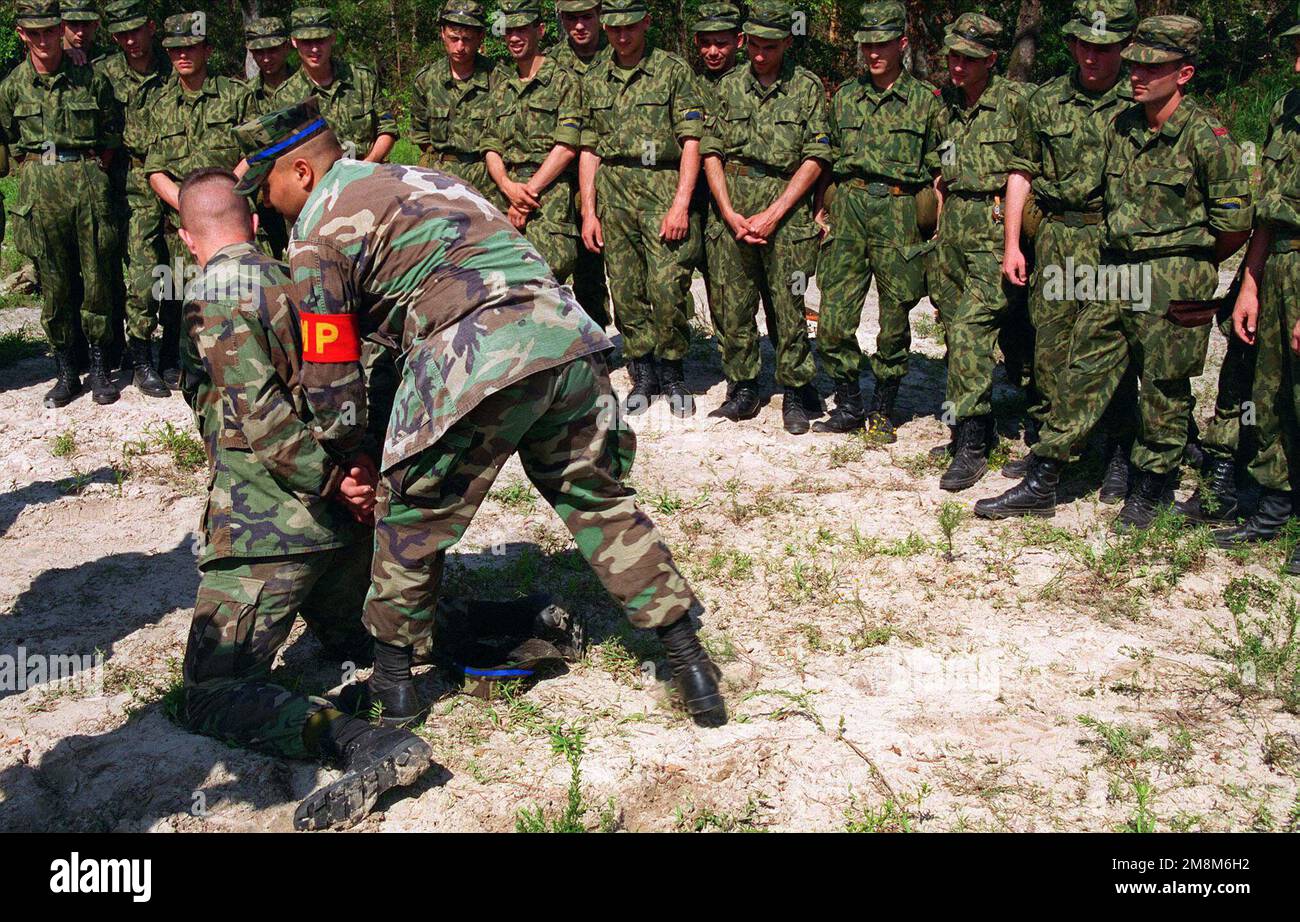 CPL. Gonzales, Military Police Company, demonstrates to Georgian troops ...