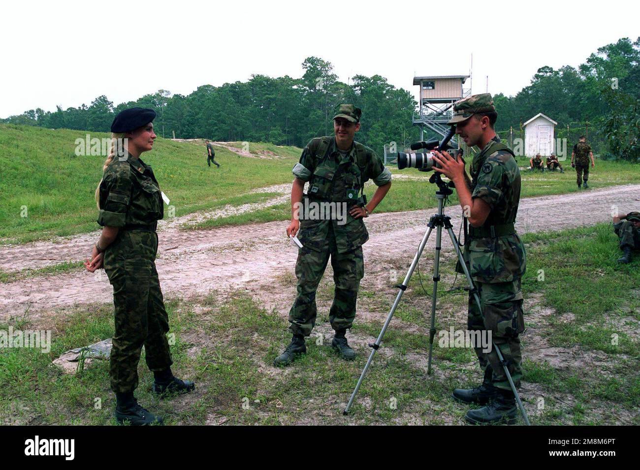 A female Ukrainian Marine Medical Officer is interviewed by US Army Reserve Specialists (SPC) S.R. Cwalina, a Combat Photographer from 982nd Signal Company, attached to the 6th Marine Regiment during Operation COOPERATIVE OSPREY 96 held at Camp Lejeune, NC. Cooperative Osprey, under the Partnership for Peace program, will provide interoperability training in peacekeeping and humanitarian operations along NATO/IFOR standards, with an emphasis on individual and collective skills. The three NATO countries providing troops are the United States, Canada, and the Netherlands. The 16 'Partnership for Stock Photo