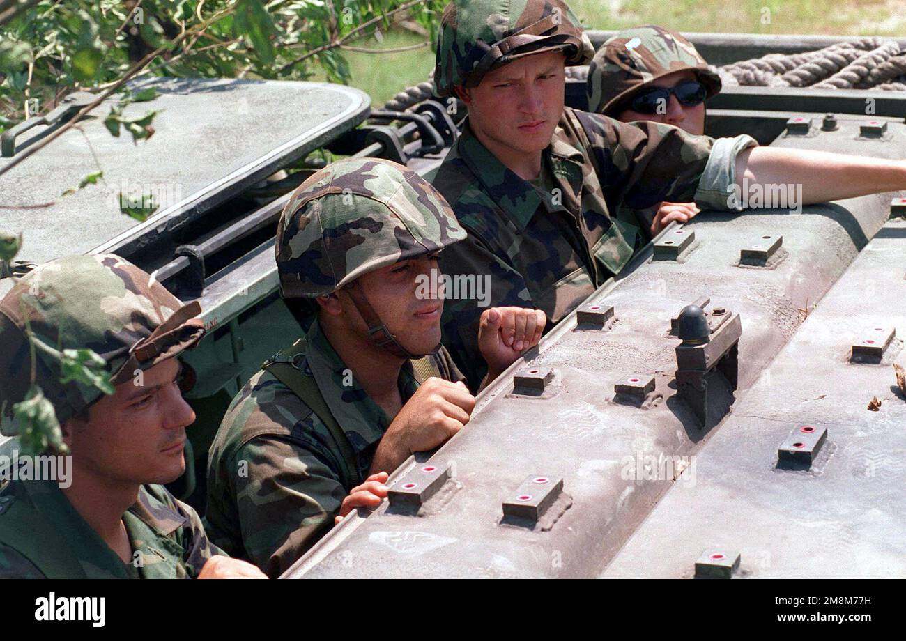 US Marine Corps soldiers from Company 4 hang out of an Amphibious ...