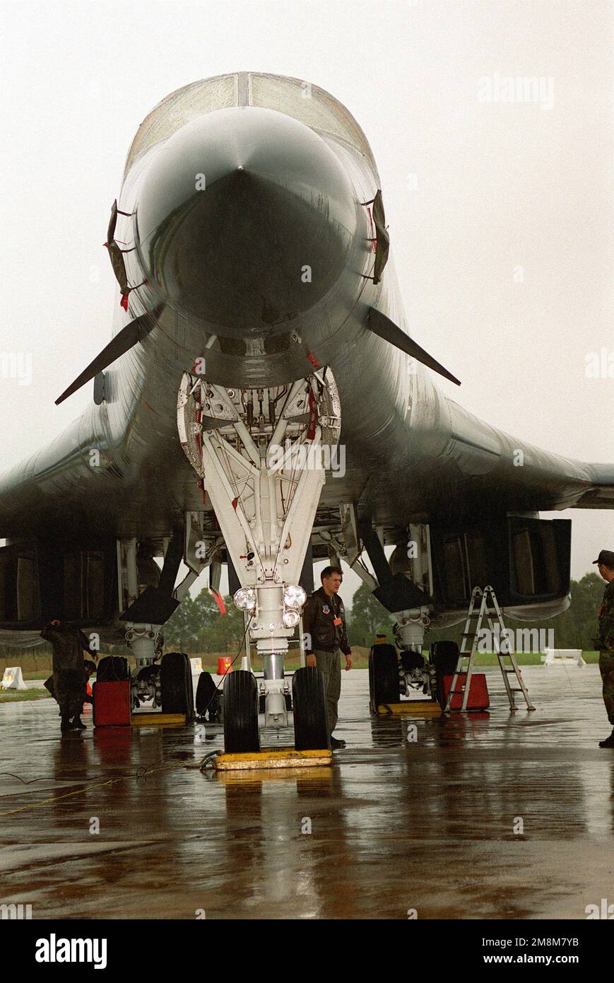 A front view of a B1 aircraft as crewmen prepare it to carry members