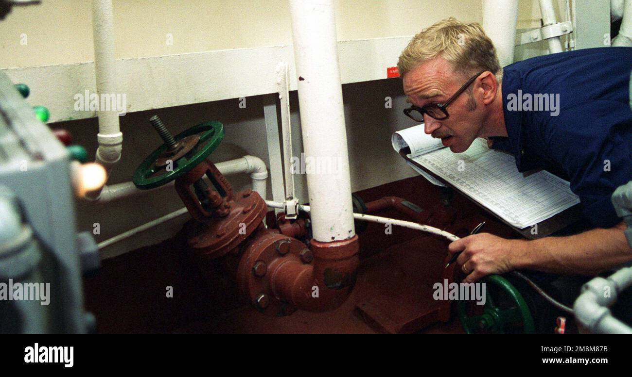 US Navy Engineman 1ST Class Michael Pooley records readings from gauges