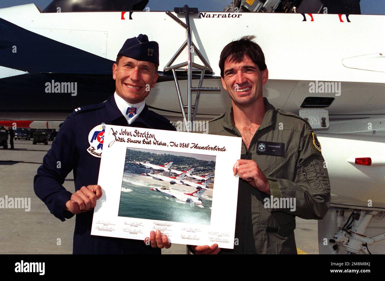 USAF Captain Daniel R. Torweihe, USAF Thunderbird's narrator, presents John Stockton, two time Olympic gold medalist and point-guard for the Utah Jazz, a momento of his flight with the demonstration team. Base: Fairchild Air Force Base State: Washington (WA) Country: United States Of America (USA) Stock Photo