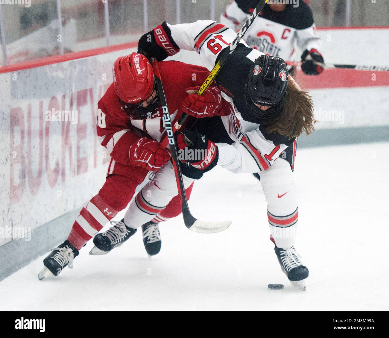 Columbus, Ohio, USA. 14th Jan, 2022. Ohio State Buckeyes defenseman Lauren Bernard (19) fights for the puck against Wisconsin Badgers forward Maddi Wheeler (28) in their game in Columbus, Ohio. Brent Clark/CSM/Alamy Live News Stock Photo