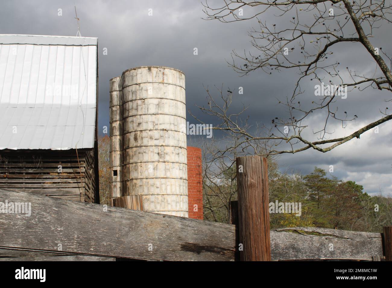 Old barn with red and white grain silos Stock Photo