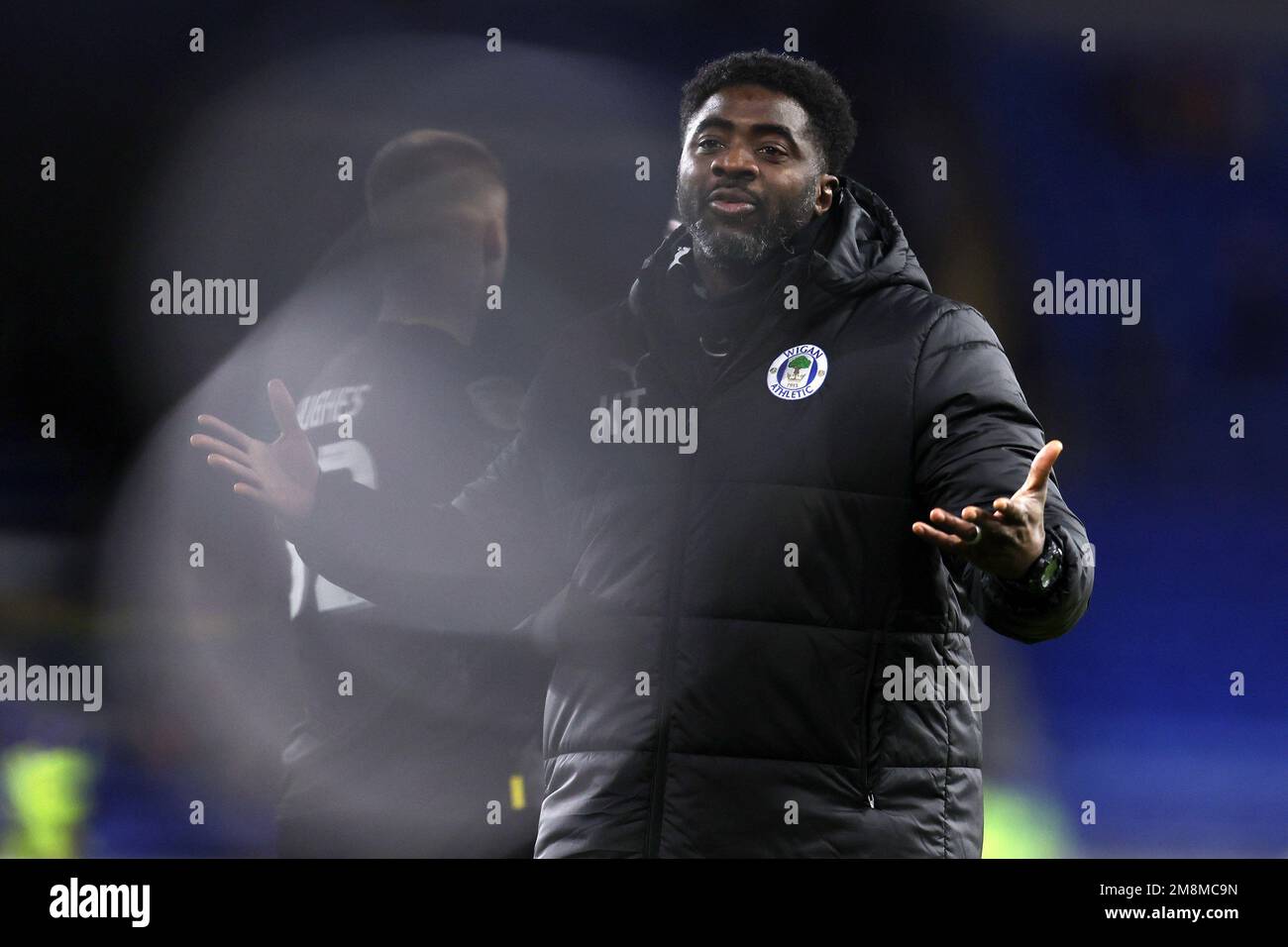 Cardiff, UK. 14th Jan, 2023. Kolo Toure, the manager of Wigan Athletic thanks the Wigan fans after the game. EFL Skybet championship match, Cardiff city v Wigan Athletic at the Cardiff City Stadium in Cardiff, Wales on Saturday 14th January 2023. this image may only be used for Editorial purposes. Editorial use only, license required for commercial use. No use in betting, games or a single club/league/player publications. pic by Andrew Orchard/Andrew Orchard sports photography/Alamy Live news Credit: Andrew Orchard sports photography/Alamy Live News Stock Photo