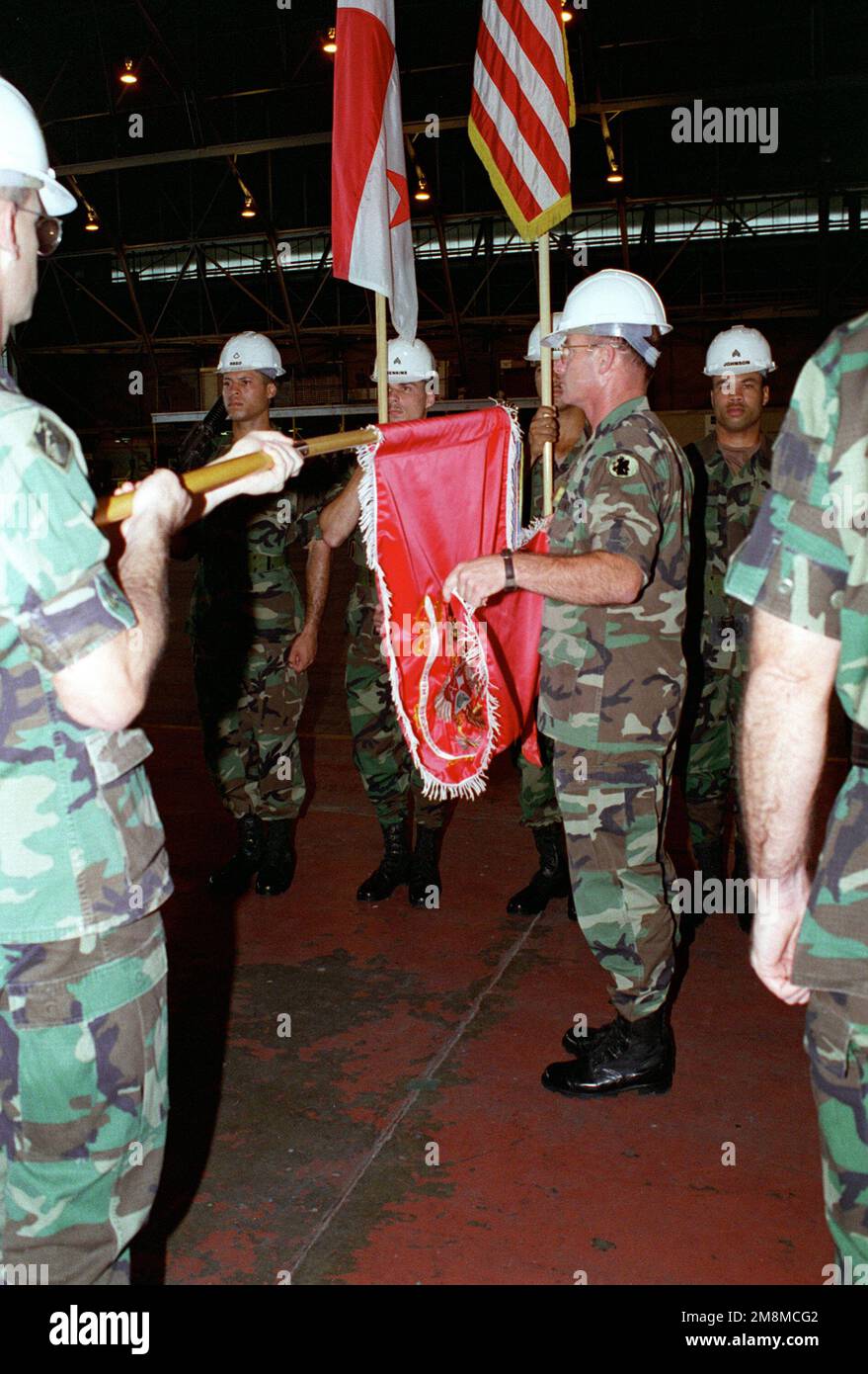 Lieutenant Colonel James E. Koch Commander of the 536th Engineer Combat Battalion (Heavy) retire the colors of his unit during the inactivation ceremonies for the 536th Eng. Comb. BN (H) held in hangar #4. Base: Howard Air Force Base Country: Panama (PAN) Stock Photo