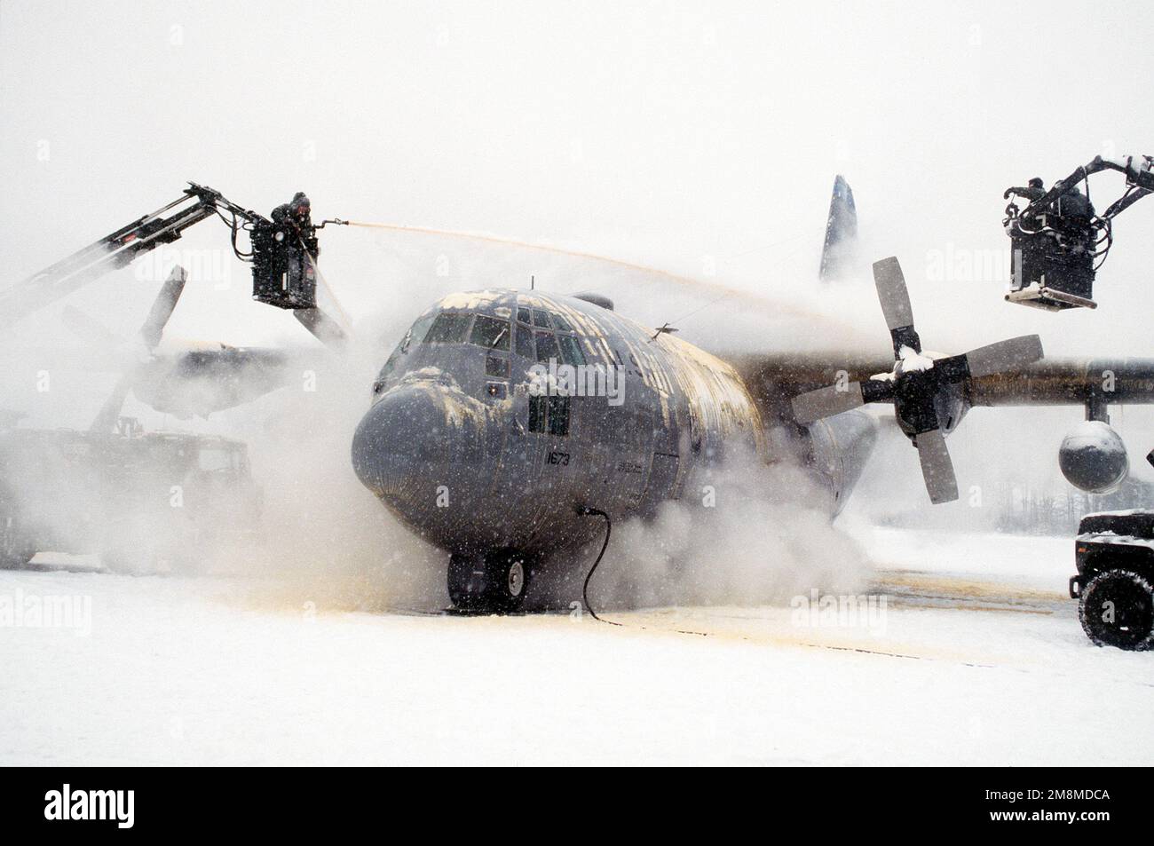 Working under frigid conditions, crew chief and ground support personnel de-ice a 40th Airlift Squadron (AS) C-130H on the snow covered ramp at this United States Air Force Europe (USAFE) base. The 40th AS is assigned to the 7th Wing, Dyess Air Force Base, Texas and is deployed to Ramstein to support Operations Joint Endeavor and Joint Guard from 4 Dec. 1996 to 23 Jan. 1997. Exact Date Shot Unknown. Subject Operation/Series: JOINT ENDEAVORJOINT GUARD Base: Ramstein Air Base State: Rheinland-Pfalz Country: Deutschland / Germany (DEU) Stock Photo