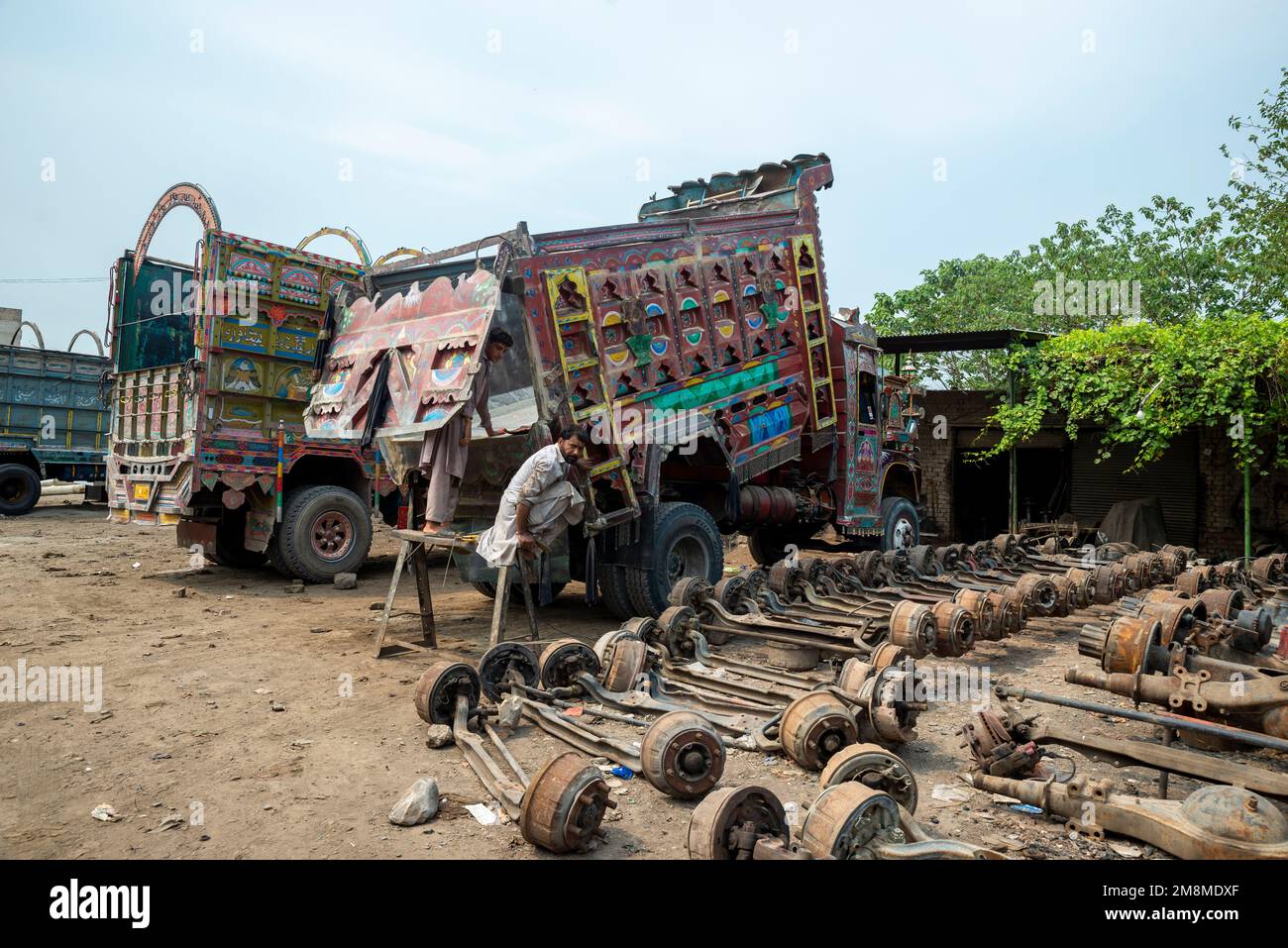 Colorfully painted trucks at the workshop, Peshawar, Pakistan Stock Photo
