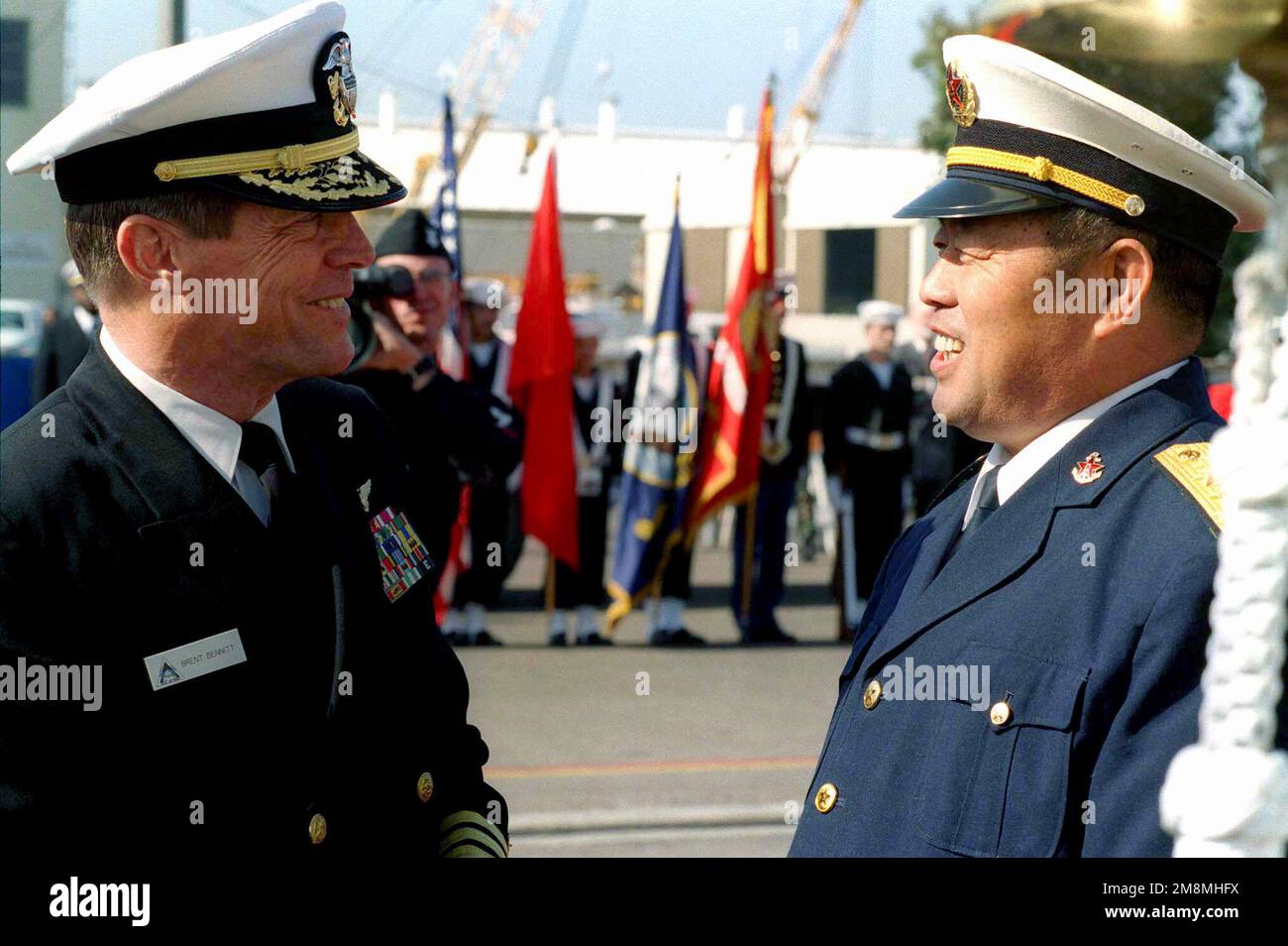 US Navy Vice Admiral Brent Bennitt (Left), Commander Naval Air Forces Pacific, and Chinese Vice Admiral Wang (Right), Commander of the Chinese South Sea Fleet, exchange goodbyes on the pier at Naval Station North Island, San Diego, California. This marks the first time Chinese warships have crossed the Pacific and visited the Continental United States. The Luhu Class Destroyer HARIBING (DDG 112), Luda II Class Destroyer, ZHUHAI (DDG 166), and a supply ship, the Fusu Class, NANYUN (AOR/AK 953) (Chinese vessels not shown), stopped at Naval Station, North Island, San Diego, California. The next p Stock Photo