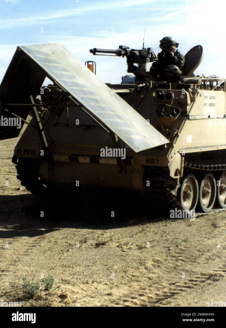 US Army, SPECIALIST (SPC) Kevin Marsh and Private First Class (PFC) Shawn Burgos, A Company, 299th Engineer Battalion, 4th Infantry Division, Fort Hood, Texas, stand in open hatches in an M113 Armored Personnel Carrier (APC), mock-up Grizzly breaching system (mine field), during the Advanced Warfighting Experiment (AWE) at the National Training Center, Fort Irwin, California. More than 6,000 soldiers took part in the six-week exercise that capped nearly two years of training. The AWE tested 72 initiatives ranging from new computer equipment like the Applique to reorganization of unit structure Stock Photo