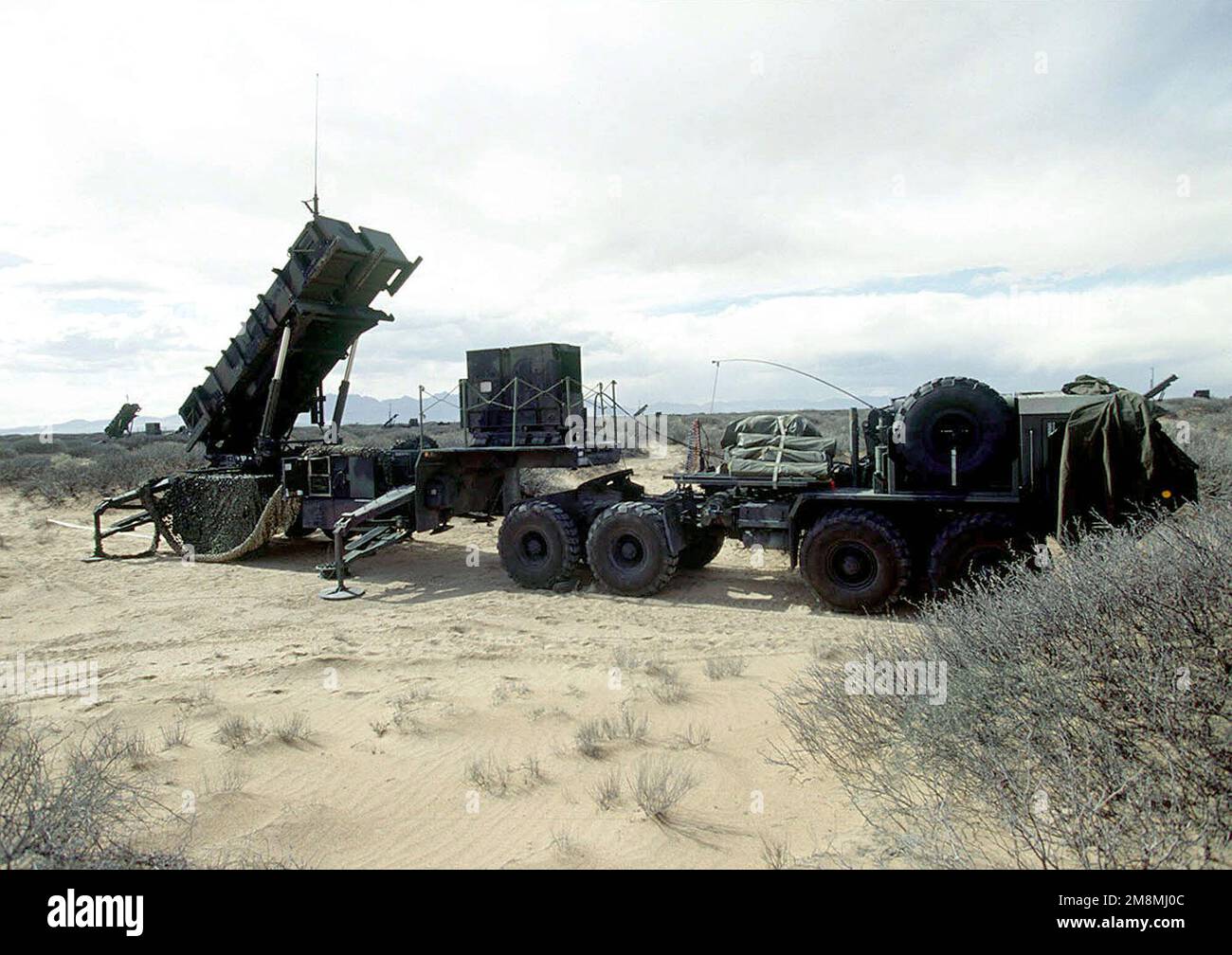 At their Fort Bliss site, the Patriot semitrailer launch platform and missile cannisters from the 35th Air Defense Artillery, Fort Lewis, Washington guard the skies against aerial attack. The 35th ADA while deployed to Fort Bliss will provide Patriot missile defense against enemy fighter strikes and simulated SCUD missile launches during the world's largest joint service, multi-national tactical air operations exercise. Subject Operation/Series: ROVING SANDS '97 Base: El Paso State: Texas (TX) Country: United States Of America (USA) Stock Photo