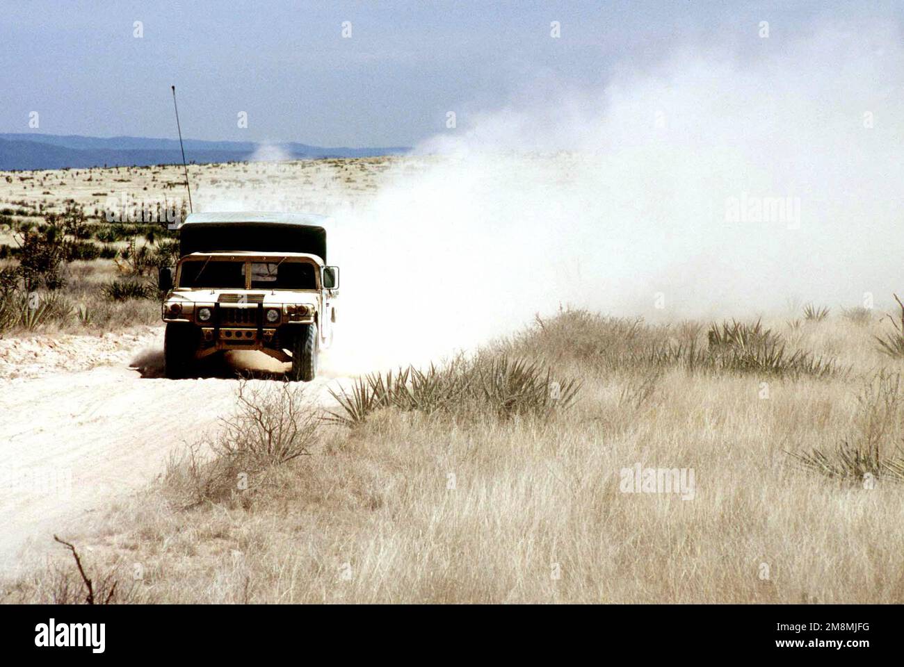 A High-Mobility Multipurpose Wheeled Vehicle (HMMWV) creates a cloud of ...